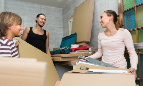 Removal team loading furniture into a van