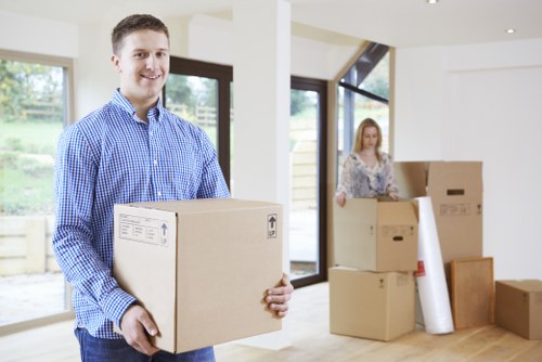 Mover wearing PPE while handling boxes during a Barking removal