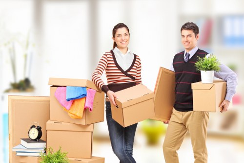 Packed moving boxes and furniture ready for transport in Barking