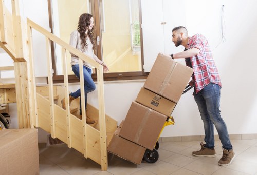 Careful lifting of heavy furniture during a local Barking relocation