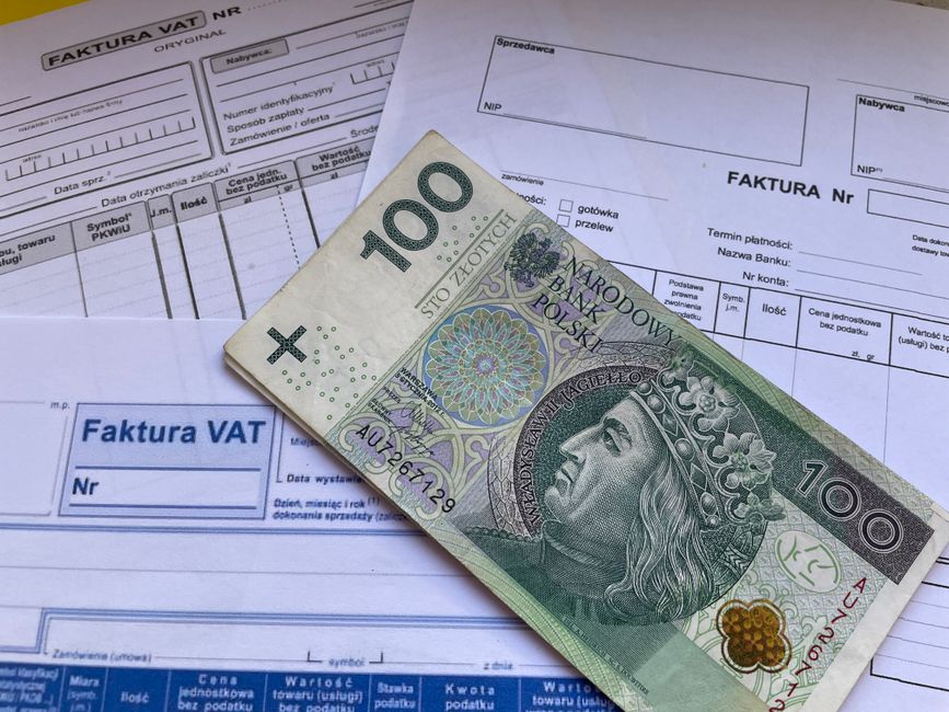 A close-up photograph of a printed business plan document placed on a bed with light-colored, slightly textured bedding. The document is titled 'BUSINESS PLAN' and includes sections such as 'What is y